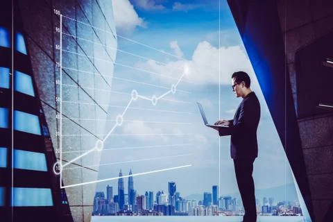 Businessman using laptop with graph statistical analysis ,Business success co Stock Photos
