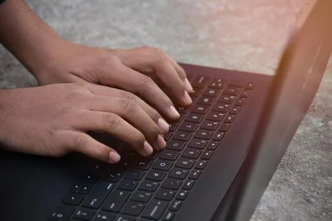 Businessman using laptop with hands typing on a keyboard 写真素材
