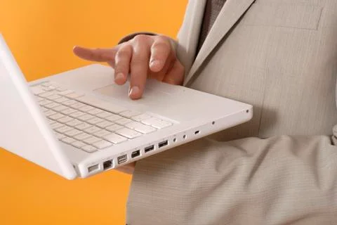 Businessman using laptop, middle section, close up Stock Photos