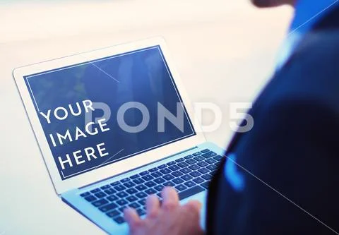 Businessman using laptop on street mock up PSD Template