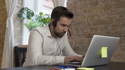 Businessman using laptop while working in a call center Video stock 233432293