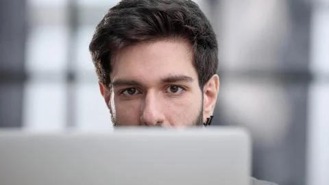 Businessman using a laptop while working late in his office Stockfoto's