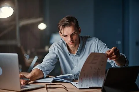 Businessman using a laptop to work with documents . Stock Photos