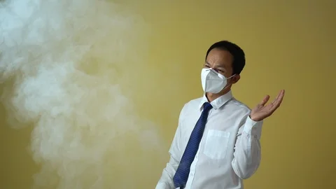 A businessman using a mask for protect an air toxic.  Stock Footage 123778117