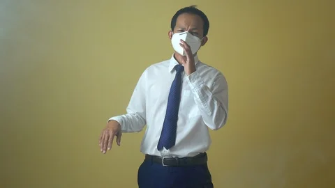 A businessman using a mask for protect an air toxic.  Stock Footage 123778210