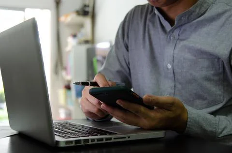 Businessman using mobile and computers are working on searching for informati Stock Photos