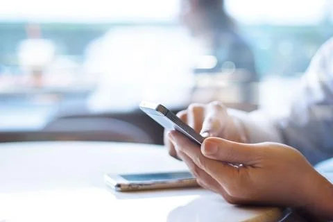 Businessman using mobile payments in office background Stock Photos