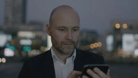 Businessman Using a Mobile Phone and Looking Around Stock Footage 80683092