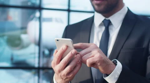 Businessman Using Mobile Phone at the Departure Lounge in the Airport. Stock Footage
