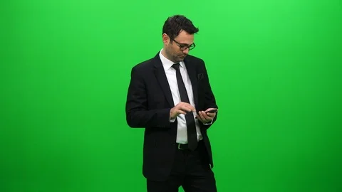 Businessman Using Mobile Phone on Green Screen Stock Footage 88651626