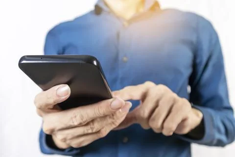 Businessman using mobile phone to read messages and touch the mobile screen.. Stock Photos