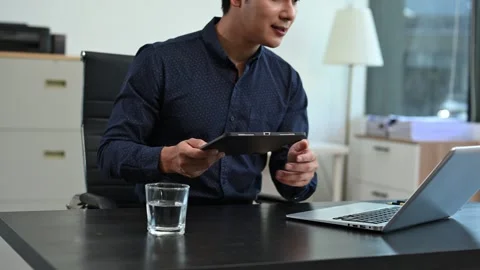Businessman using mobile phone, tablet.Closeup on blurred background. Stock Footage 313460768