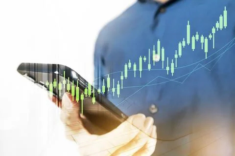 Businessman using mobile phone to view investment information and mobile ph.. Stock Photos