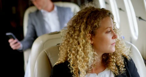 Businessman using mobile phone while travelling in private jet 4k Stock Footage 90763784