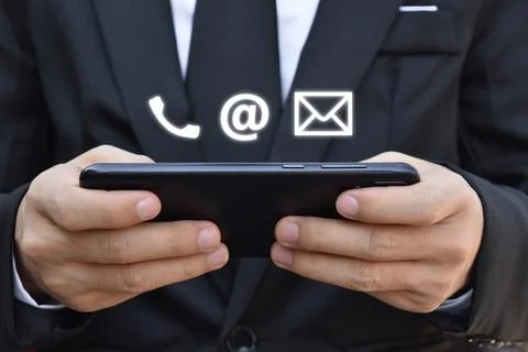 Businessman using mobile smartphone. Concept of Contact Us, customer support. Stock Photos