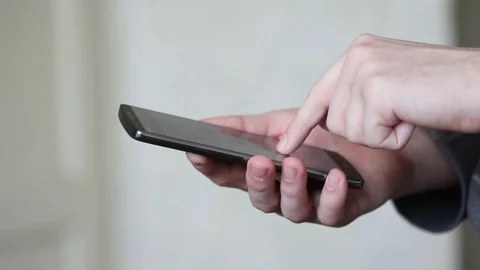 Businessman using mobile smartphone in office Stockbeeldmateriaal 73544406