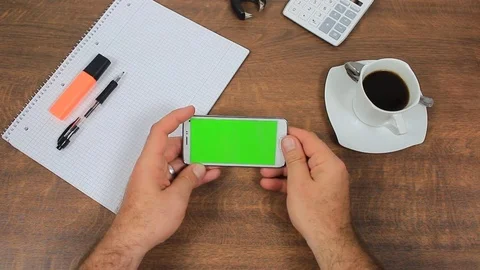 Businessman using a modern smartphone with green screen at his desk Stock Footage
