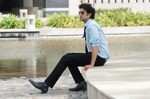 Businessman using a palmtop at poolside 写真素材