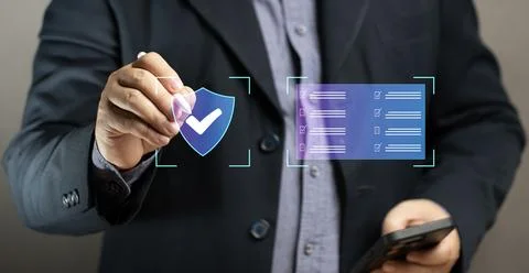 Businessman using pen on virtual screen with shield of security, online sec.. Stock Photos