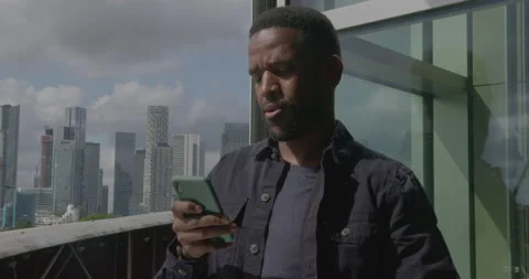 Businessman using Smart phone Technology in  Office , looking at Skyline Stock Footage 212579281