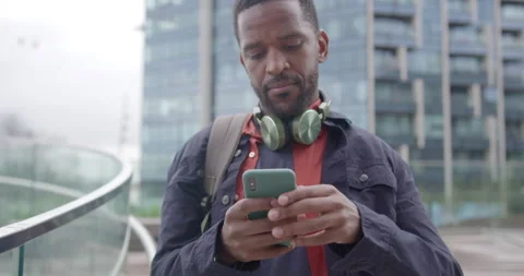 Businessman using Smart phone Technology wearing Headphones, Commuting to Office Stock Footage 212611742