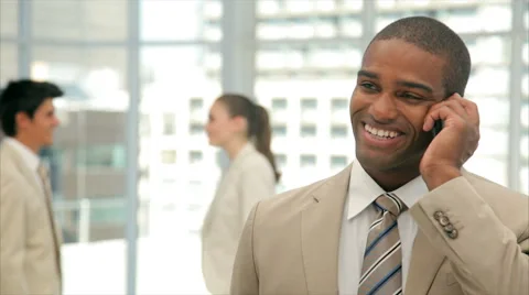 Businessman using smart phone while colleagues shaking hands Stock Footage 52685667