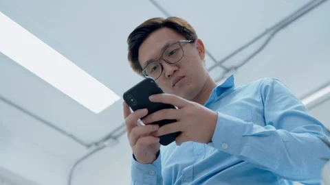 Businessman Using Smartphone browsing internet, checking email. Video stock 128235111