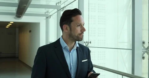 Businessman using smartphone to call home on his commute Stock Footage 74860432