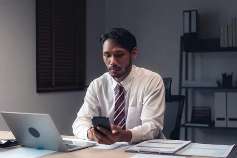 Businessman using smartphone to checking report while analysis financial an.. Stock Photos