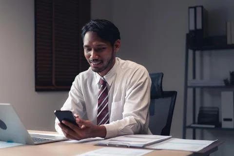 Businessman using smartphone to checking report while analysis financial an.. Foto stock