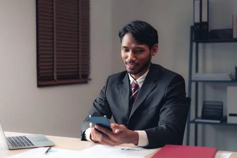 Businessman using smartphone to checking report while analysis financial an.. Stock Photos