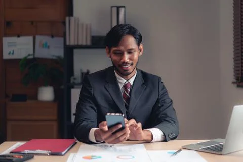 Businessman using smartphone to checking report while analysis financial an.. Stock Photos