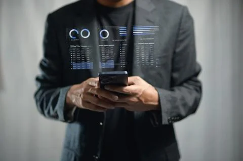 Businessman Using Smartphone with Digital Data Overlay in Modern Office Env.. Stockfoto's