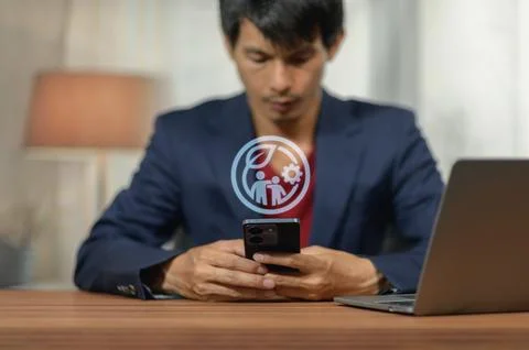 Businessman Using Smartphone with Digital Technology Icon and Laptop Stock Photos