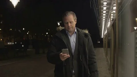 Businessman using on smartphone in the evening Stock Footage 69255425