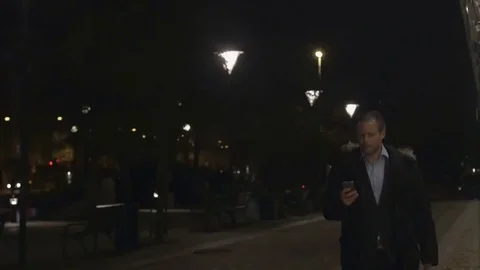 Businessman using on smartphone in the evening Stock Footage 69255430