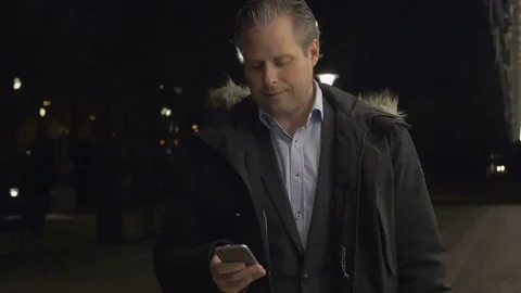 Businessman using on smartphone in the evening Stock Footage 69255461