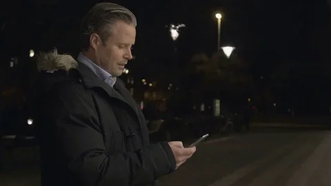 Businessman using on smartphone in the evening Stock Footage 69255514