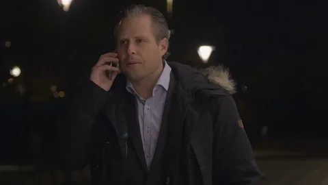 Businessman using on smartphone in the evening Stock Footage 69255540