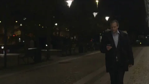 Businessman using on smartphone in the evening Stock Footage 69255547