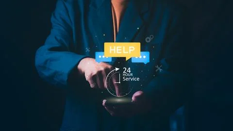 Businessman using a smartphone with floating HELP chat bubbles and 24 hour .. Stock Photos