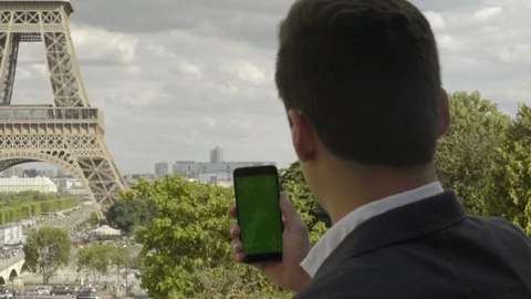Businessman using smartphone with Green Screen at Eiffel Tower, Touchscreen with 스톡 동영상 111924261