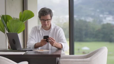 Businessman using smartphone at home interior, social media and internet Stock Footage 251363082