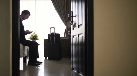 Businessman using smartphone for internet in hotel during business trip Video stock 10604262