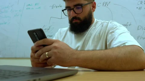 Businessman Using Smartphone at Office Desk During Work 스톡 동영상 341768163