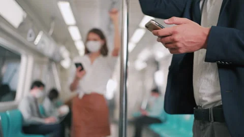 Businessman using smartphone on the skytrain or subway Stock Footage 150359081