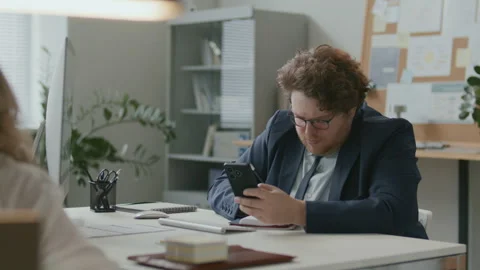 Businessman Using Smartphone, Taking Notes and Working on Computer in Office Stock Footage 331557042