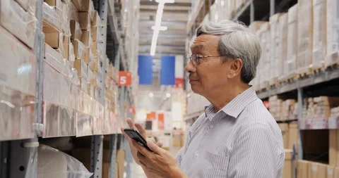 Businessman using smartphone for working at warehouse. Stock Footage 116549952