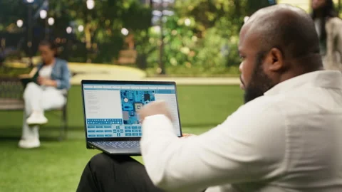 Businessman using software with microchip and circuit board interface 動画素材 343501410