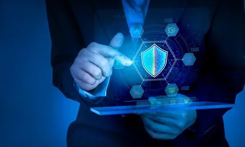 Businessman using tablet with AI cybersecurity interface and digital shield.. Stock Photos